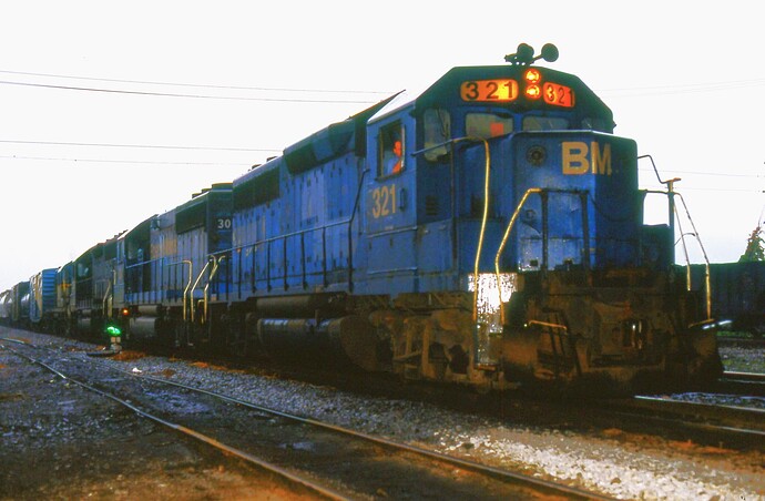 D&H. B&M GP40-2 #321 & other units ready to head north in Binghamton, NY. Aug 1984
