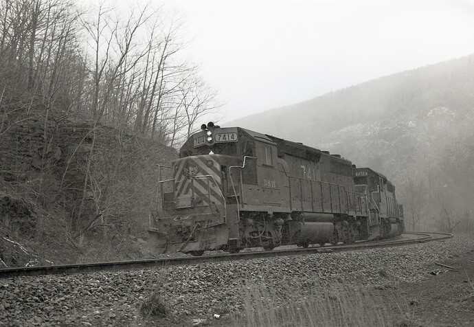 D&H. GP39-2 #7414 & GP38-2 #7616 & U23B #2314. North across from Jim Thorpe, snow squall in March 1980.