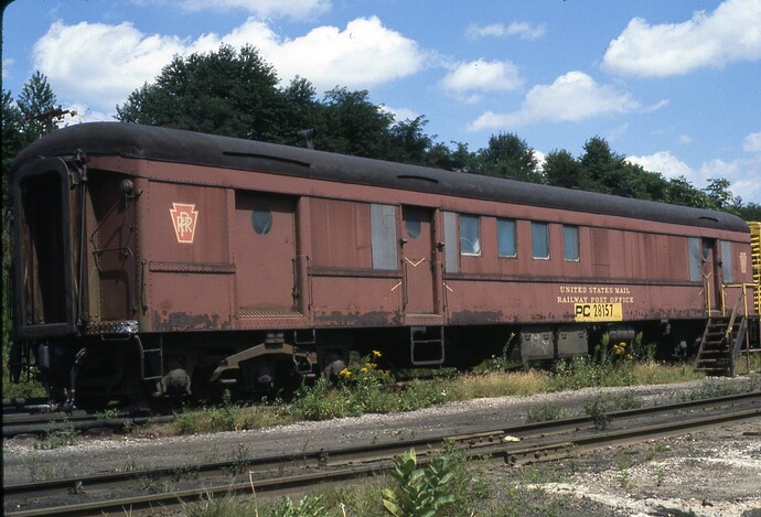 Conrail. Ex PRR RPO car. Altoona, PA scrap line. August 16, 1977