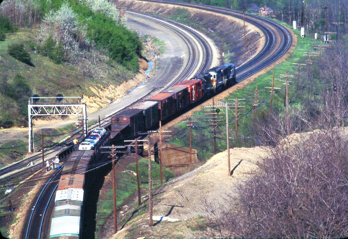 CR. An eastbound freight is east from Gallitzin, looking toward Bennington Curve,from Tunnel Hill, PA. Aug 1978