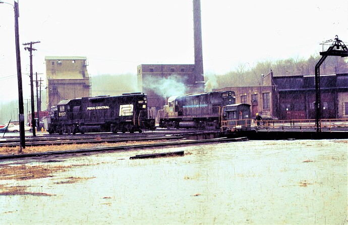 Photo 5. Ex PC GP38-2  #8107 & ex L&HR C-420 #2072. Bethlehem-Allentown engine terminal in the rain.  April 28, 1977