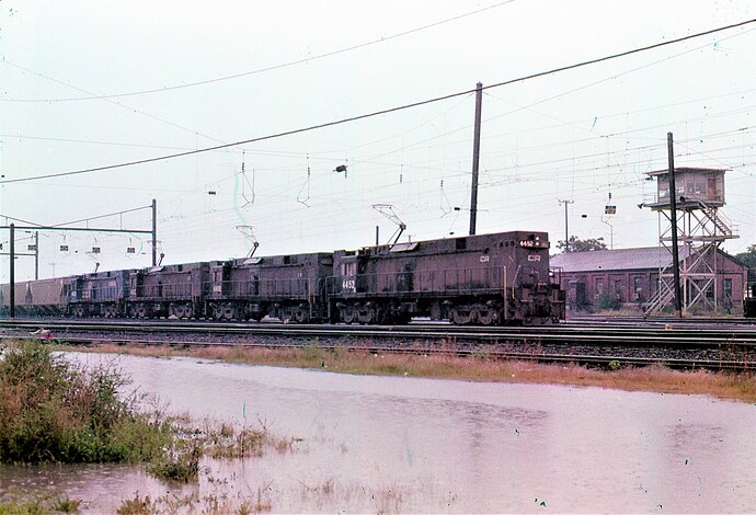 Conrail. E-44 #4452, #4400, #4432 & #4422 on heavy grain train in a heavy rain at Harrisburg, PA. Sept 1979