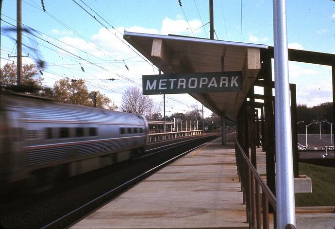 Penn Central. Metroliner eastbound at track speed (around 100 MPH). Metropark, Iselin, NJ. Oct. 1971
