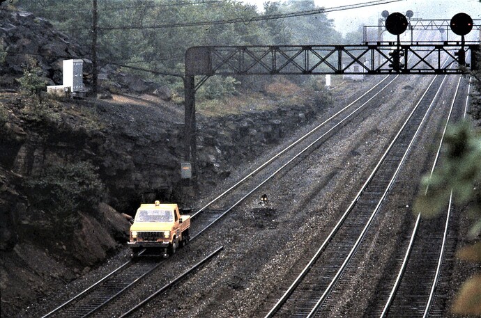 Conrail. Maintenance hi-wheeler truck westbound at Benny Curve. Sept 1980