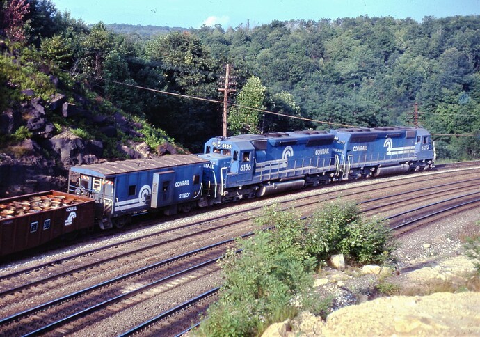 Conrail. SD-45 #6156 & 6125 are pushing west freight with caboose #21150 towards Gallitzin tunnels. Aug. 1980