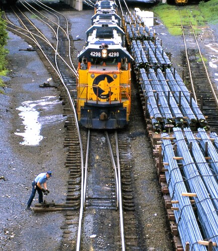 Conrail. Enola, PA yards with Chessie freight with GP40-2  #4298 leading. Crewman throughing switch. Sept  1984