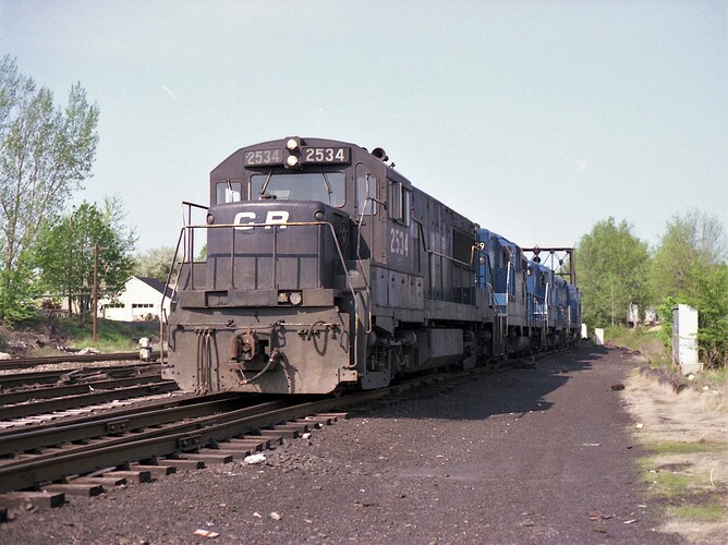 Conrail.  GE U25B #2534 & freight, west end of WX Weston Manville tower plant,  NJ. June 18, 1982