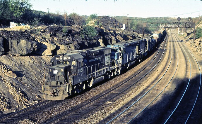 CR. GP38-2 #8060, ex RDG SD45 #6103 (blt 8-68) ex-PRR SD45 #6165 (blt 1-67) & 4th unit. east at Benny, Early morning in May, 1977.