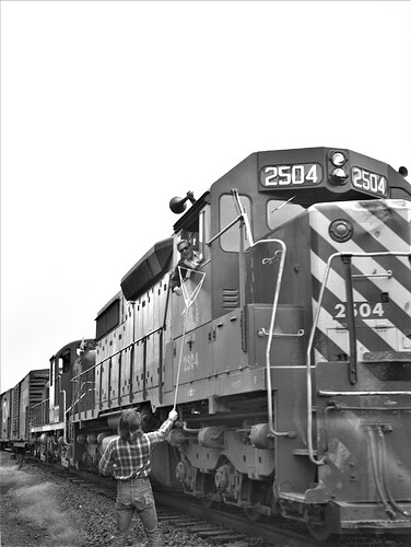 CNJ. SD-35 #2504, RS-3.  Bill Trower giving orders on the fly. RK Tower in Bound Brook, NJ . Sept. 1974