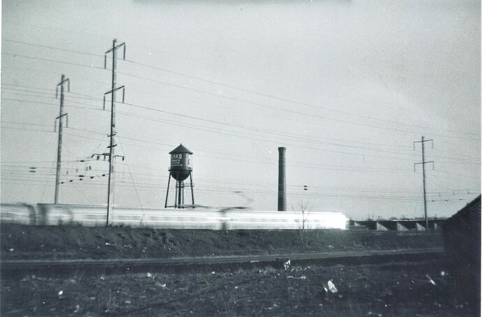 Penn Central Metroliner west at County Tower, near Jersey Avenue station. Approx 90-95 MPH.  4-11-1969.
