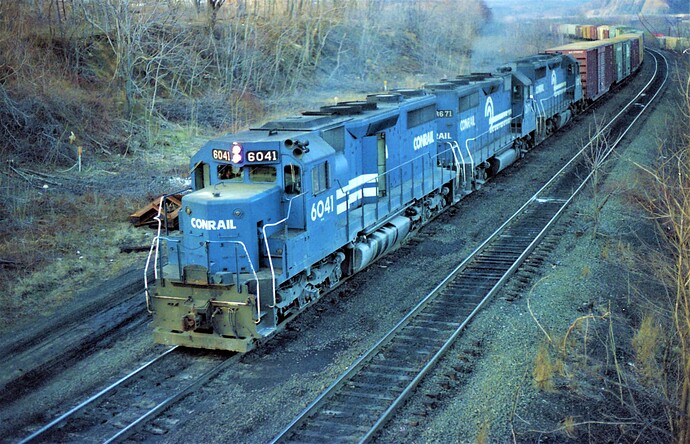 Conrail. SD35 #6041 (ex CNJ #2502), GP-35 #3671, and other unit entering Enola, PA. May 1982