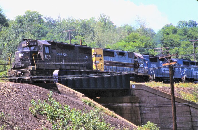 Conrail. Ex-PRR; PC SD-35 #6012, ex-EL SD45-2 #3680, #2332 & other unit eastbound from the  tunnels. Gallitzin, PA. August 1977
