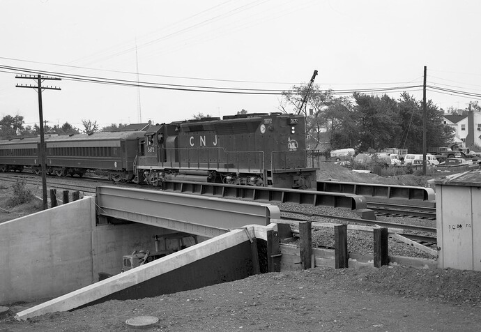 CNJ. GP40P #3672, east, crosses new 1st Ave bridge. Raritan, NJ. Aug 1974
