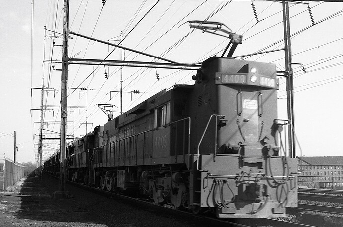 Penn Central. E-44 #4409 & mate on west freight on track 4. New Brunswick, NJ. May 1974