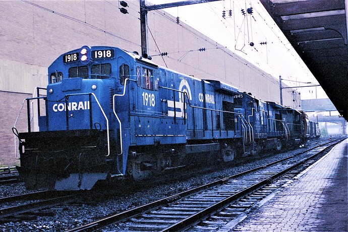 CR. B23-7 #1918, 1945 & GP unit with freight at Harrisburg, PA in the rain on 9-15-79