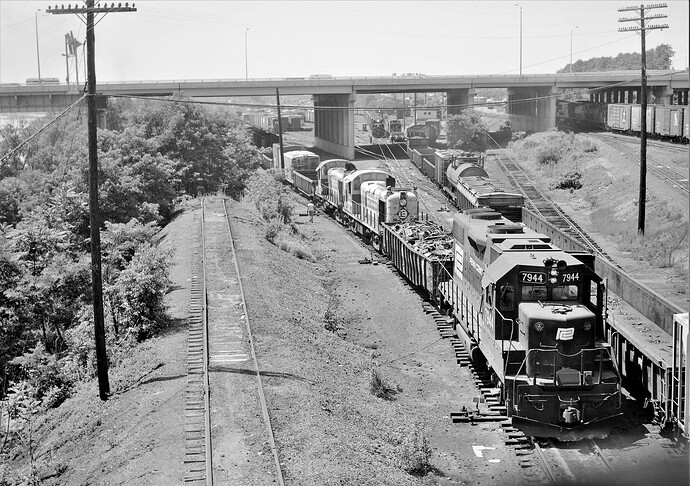 Penn Central-CR. GP38-2 #7944 switching a freight with 2 dead ex EL RS-3's. West Enola, PA. July 16, 1976