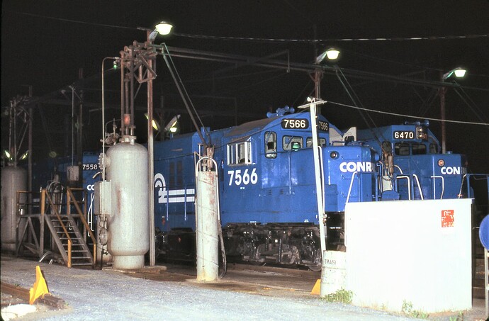 Conrail diesels being fueled in Enola, PA fueling racks.  GP-10 #7566, 7558 & SD40-2 #6470. May 5, 1986