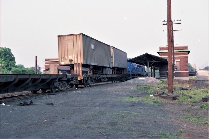 Conrail #5921 pushing cut of freight cars past Bound Brook, NJ station. 5-1979