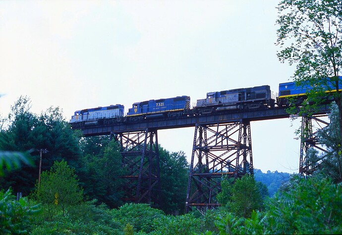 D&H. GP39-2 #7411, GP38-2 #7321, C-420 #412 & C424m #451 on  the Harpursville trestle in Harpursville, NY. Aug 1984