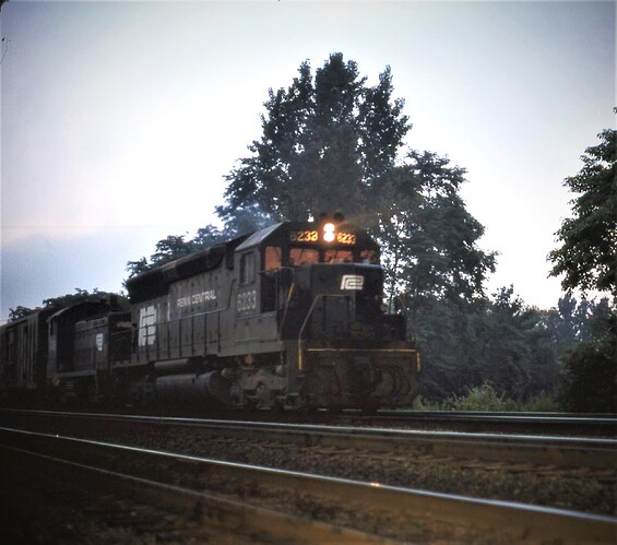 CR. Ex-PC SD45 #6233 & SW-9 #9139 east at Cove, PA. Early AM, July 16, 1976