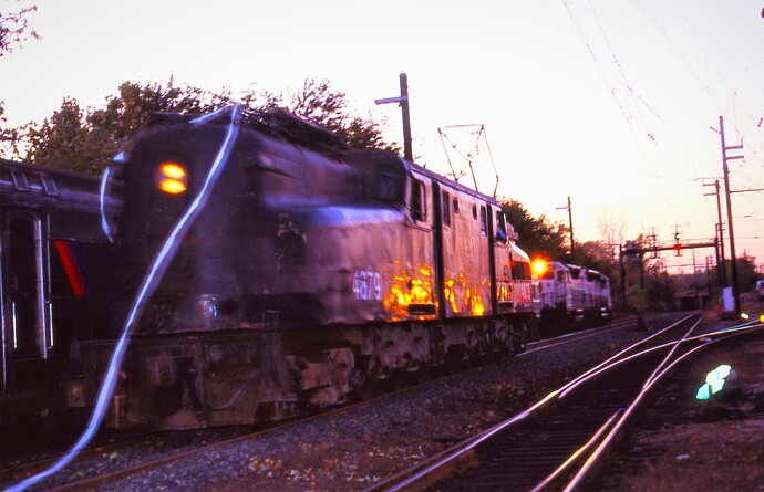NJT. Last run of GG-1 #4879 heads to the layover yard for the last time as the sun sets in November 1983.