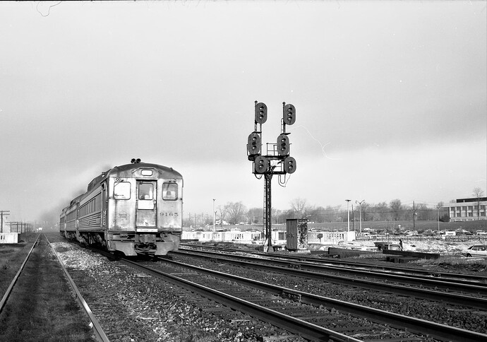 CNJ. Reading -Wall Street Broker RDC #9165 trainset is westbound at Calco, Bridgewater, NJ in April 1974