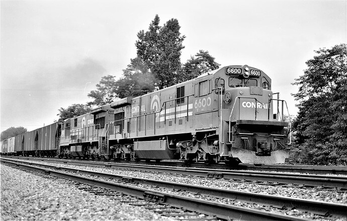 Conrail. GE C30-7 #6600 & U33-C #6882, (ex-EL #3314, renum CR #6577), eastbound at Cove, PA. August 15, 1978