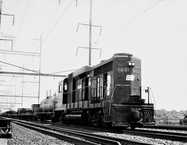 Penn Central GP-30 #2231 with westbound rail train, track 3, in New Brunswick, NJ. June 1975