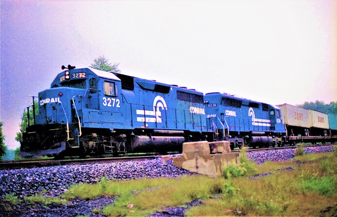Conrail GP-40 #3272 & SD-45 #6236 on TV train at Cove, PA.  Early morning rain. Sept 15, 1979