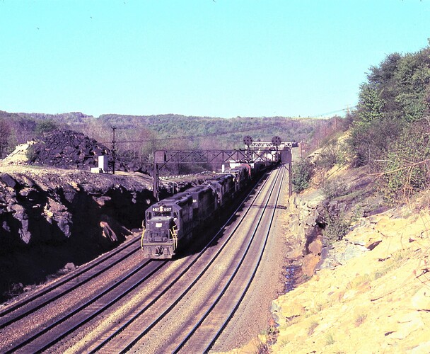 CR. Ex PC SD-40 #6017 leading eastbound freight at Benny in July  16,1976