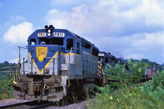 D&H GP39-2 #7411, GP38-2 #7321, C-420 #412 & CRS-36 #451 on freight at Unadilla, New York Aug. 1984.