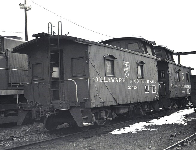 D&H. Wood cabooses #35940 & #35857. Taylor yard, Scranton, PA. March 1980