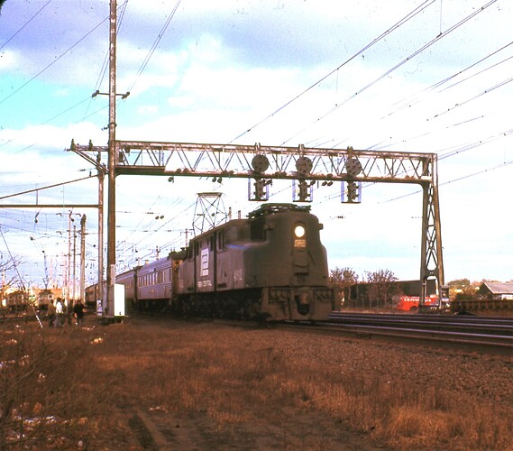 PC. GG-1 #4912 with westbound, trk 4, 'Philly Clocker' passenger. Nov 1971