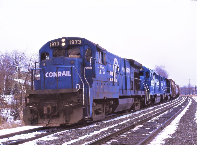 Photo 123. GE B23-7 #1973 & 2 other units with westbound freight at New Market Road, Pisc, NJ. Feb 1982