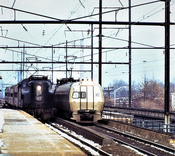 PC. GG-1 wb pass & Metroliner at Rahway, NJ. Jan 19, 1976