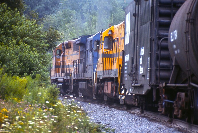 D&H GP38  #260, B&M U23B #190 & MEC U25B #231 as she crossed  Belden Tunnel Road in Belden, NY. 8-84