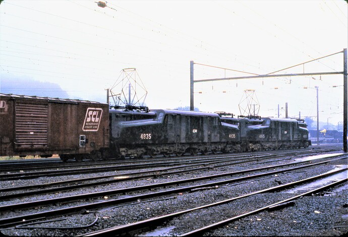 Conrail GG-1 #4865 & #4835 with freight on rainy day in east end Enola, PA. Sept 15, 1979
