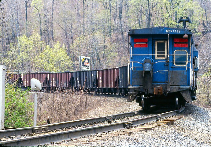 CR. Coal train heading to Enola from Rockville Bridge with caboose #21285. April 28, 1984