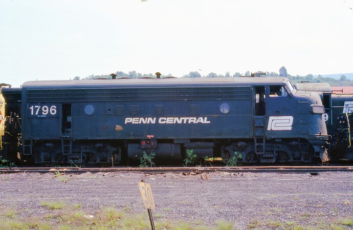 Conrail. Altoona, PA scrap line with Penn Central F-7 #1796. August 16, 1977