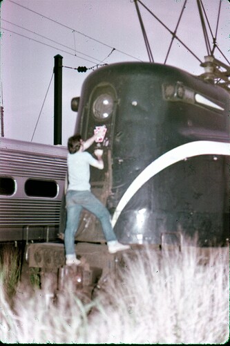 NJT. GG-1 #4883 with PRR decal being applied. South Amboy, NJ 1983