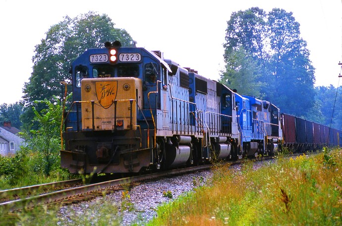 D&H. GP38-2 #7323 & others lead a freight on the trackage to Belden Hill. August 1984