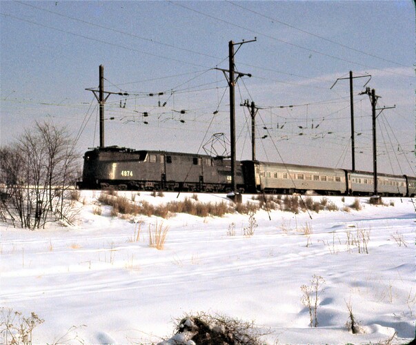 NJT. GG-1 #4874  at Union Tower, Rahway, NJ to head east on the NEC from the old NY&LB passing McGraw Yard.  Jan 1977