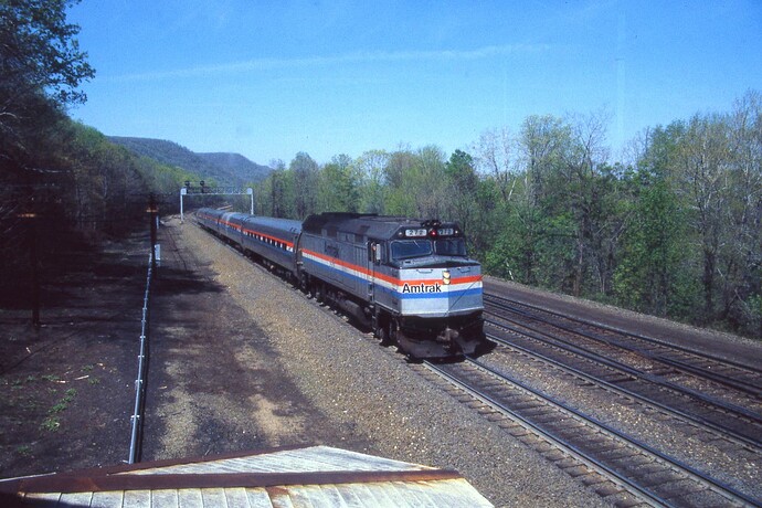 Amtrak. Pennsylvanian with F-40PH #272 (blt 12-1977, wreck-scrap 12- 1990) westbound at MG Tower on Horseshoe Curve grade. May 1986