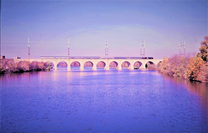 Penn Central. GG-1 eastbound passenger over Raritan River Bridge. October 1975