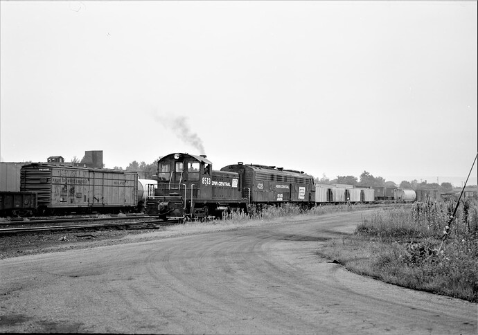 Penn Central. Harrisburg, PA. #8513 moving dead E-8 #4325.  Aug. 17, 1975