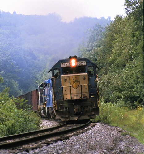 D&H GP38-2 #7323 leading freight north from Binghamton, NY. Aug 1984