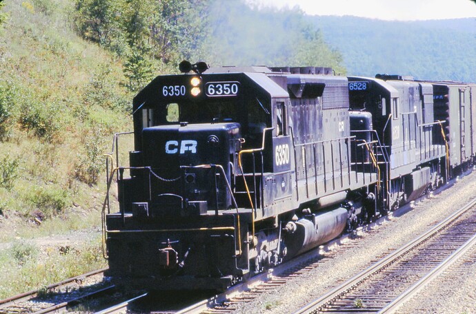 Conrail SD-40 #6350 & GE U28-C #6528 west near the tunnels at Benny Interlocking August 1977.