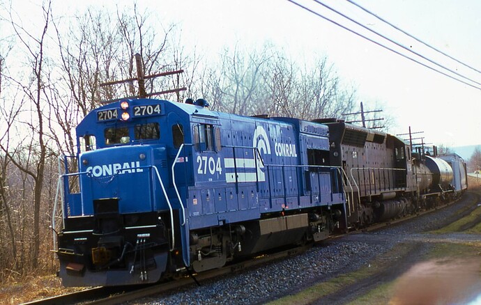 CR. U23B #2704 & SD-45 #6154 power eastbound freight on the Northern Central heading to Rockville and then to Enola.  March 1980