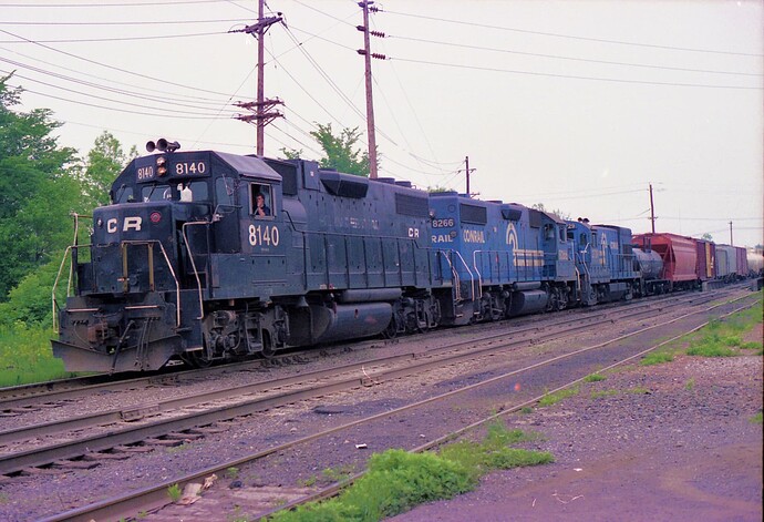 Conrail. GP-40 #8140, GP-40 #8266, GE-U23B #2729 with freight at So. Plainfield, NJ. Aug1982